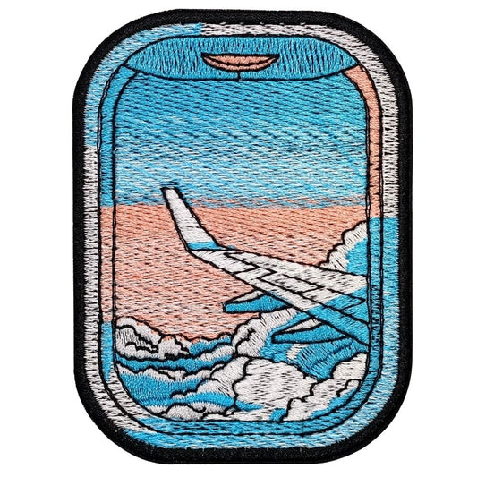 Travel-inspired patch featuring an airplane window view with aircraft wing, clouds, and soft sunset sky details embroidered patch